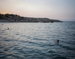 Bathers at the Easternmost point of the European Union in the the Republic of Cyprus. In the distance is the Turkish occupied part of the island.